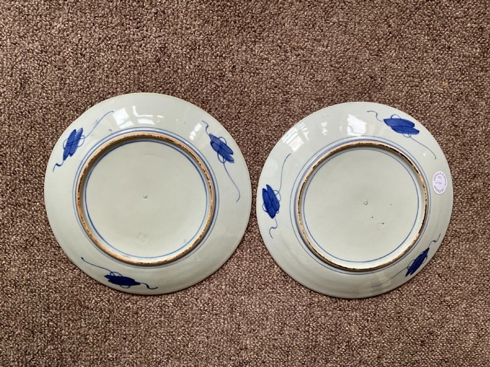 A pair of circular Japanese Imari porcelain chargers decorated with cobalt blue, iron-red, and green enamels featuring alternating floral panels around a central roundel. View II