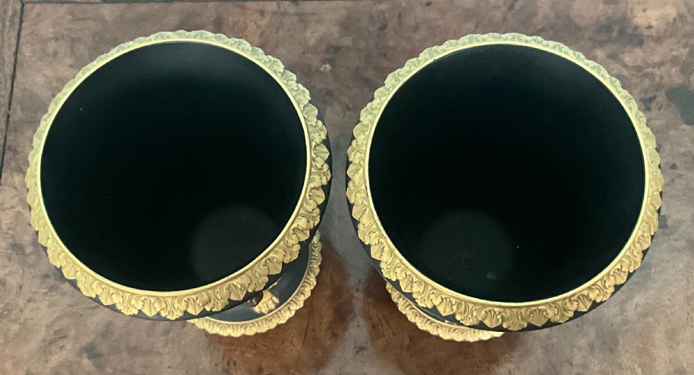 A pair of antique black basalt vases featuring gilt and bronzed neoclassical relief decorations, including lion masks and swags. View IV