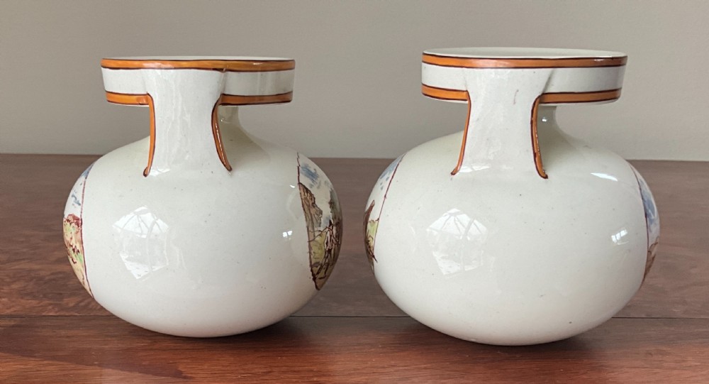 A pair of bulbous cream earthenware vases with orange-trimmed tops, decorated with painted oval cartouches depicting rural agricultural harvest scenes. View IV