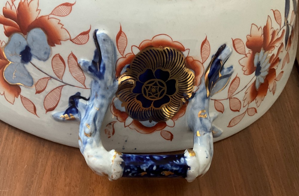 A large oval white ironstone platter and matching pierced strainer insert decorated with dark blue, terracotta, and gold floral Imari patterns. View III