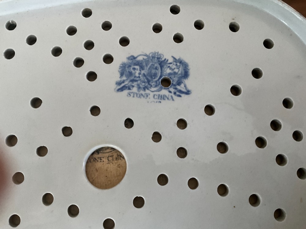 A large oval white ironstone platter and matching pierced strainer insert decorated with dark blue, terracotta, and gold floral Imari patterns. View IV