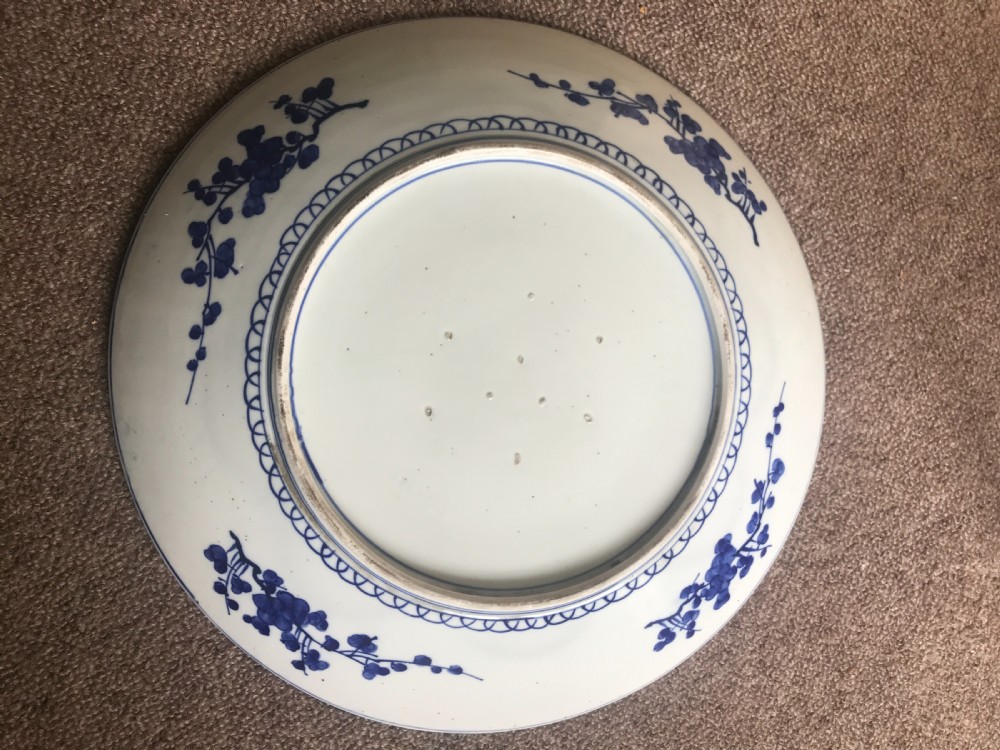 A large round Japanese ceramic plaque featuring a hand-painted blue and white design of carp fish amid cascading water, surrounded by a floral border. View II