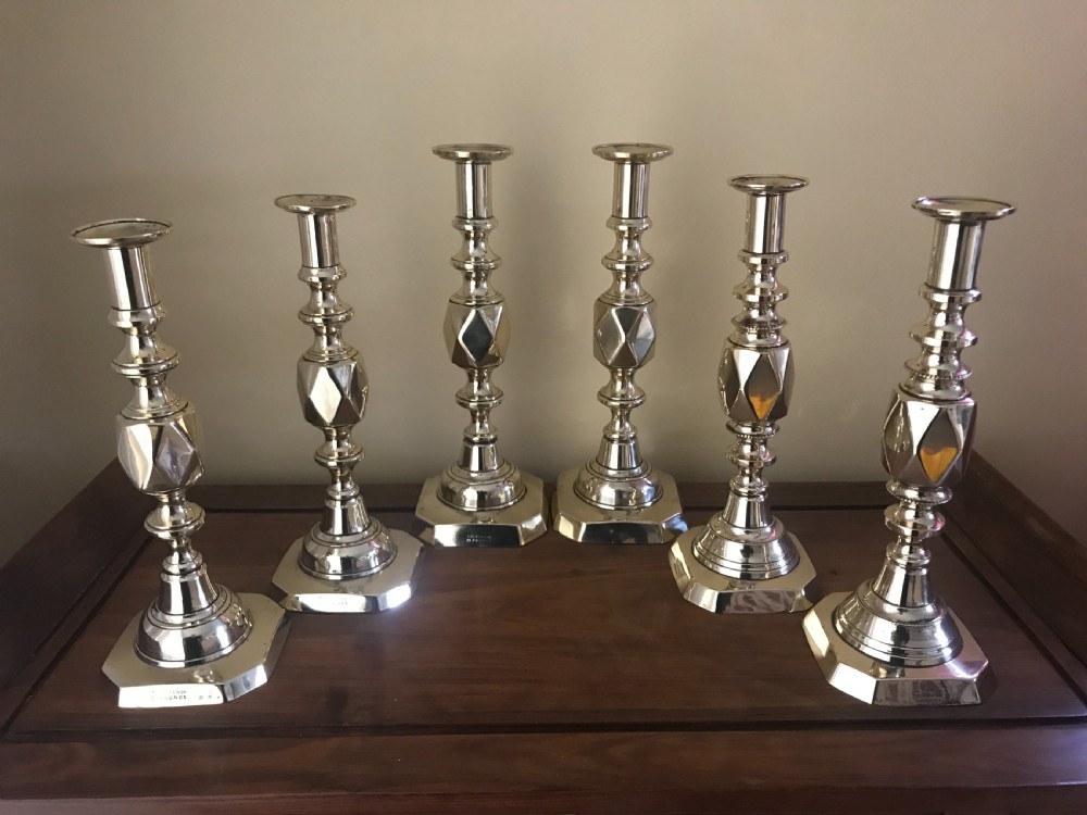 3 Pairs of Victorian `Diamond` brass candlesticks .