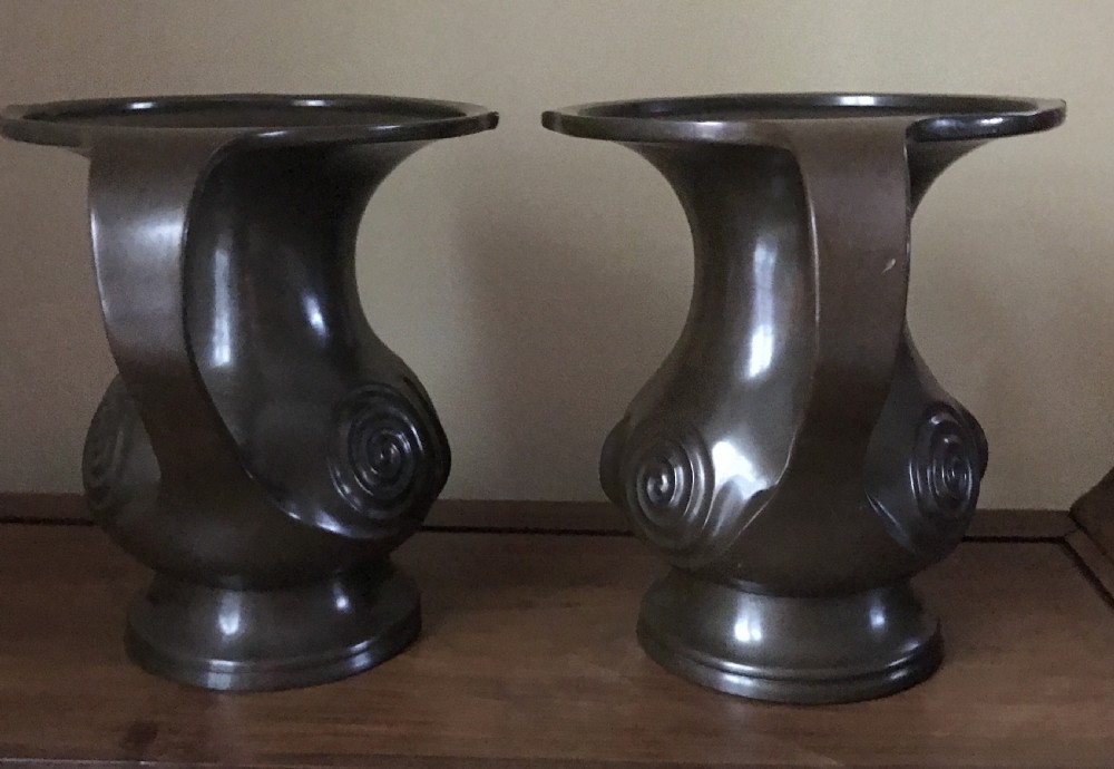 A pair of dark brown patinated bronze Japanese Mimikuchi vases featuring wide flaring rims, sweeping side handles, and relief spiral motifs on the body. View II