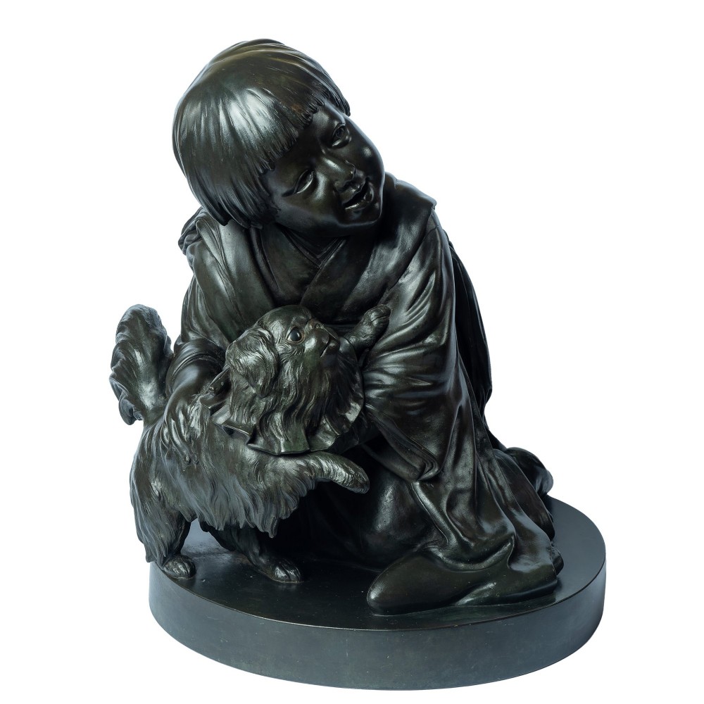 A dark patinated bronze okimono sculpture depicting a kneeling Japanese child in a kimono holding a small Pekingese dog on a rounded base. View III