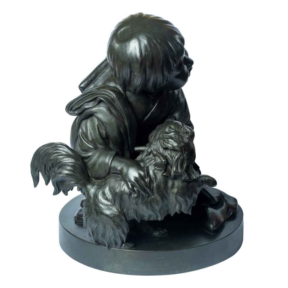 A dark patinated bronze okimono sculpture depicting a kneeling Japanese child in a kimono holding a small Pekingese dog on a rounded base. View IV