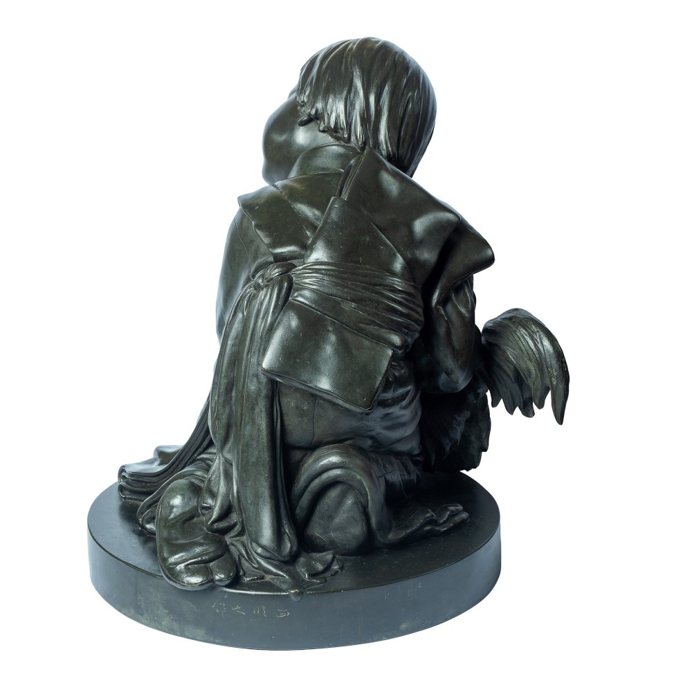 A dark patinated bronze okimono sculpture depicting a kneeling Japanese child in a kimono holding a small Pekingese dog on a rounded base. View V