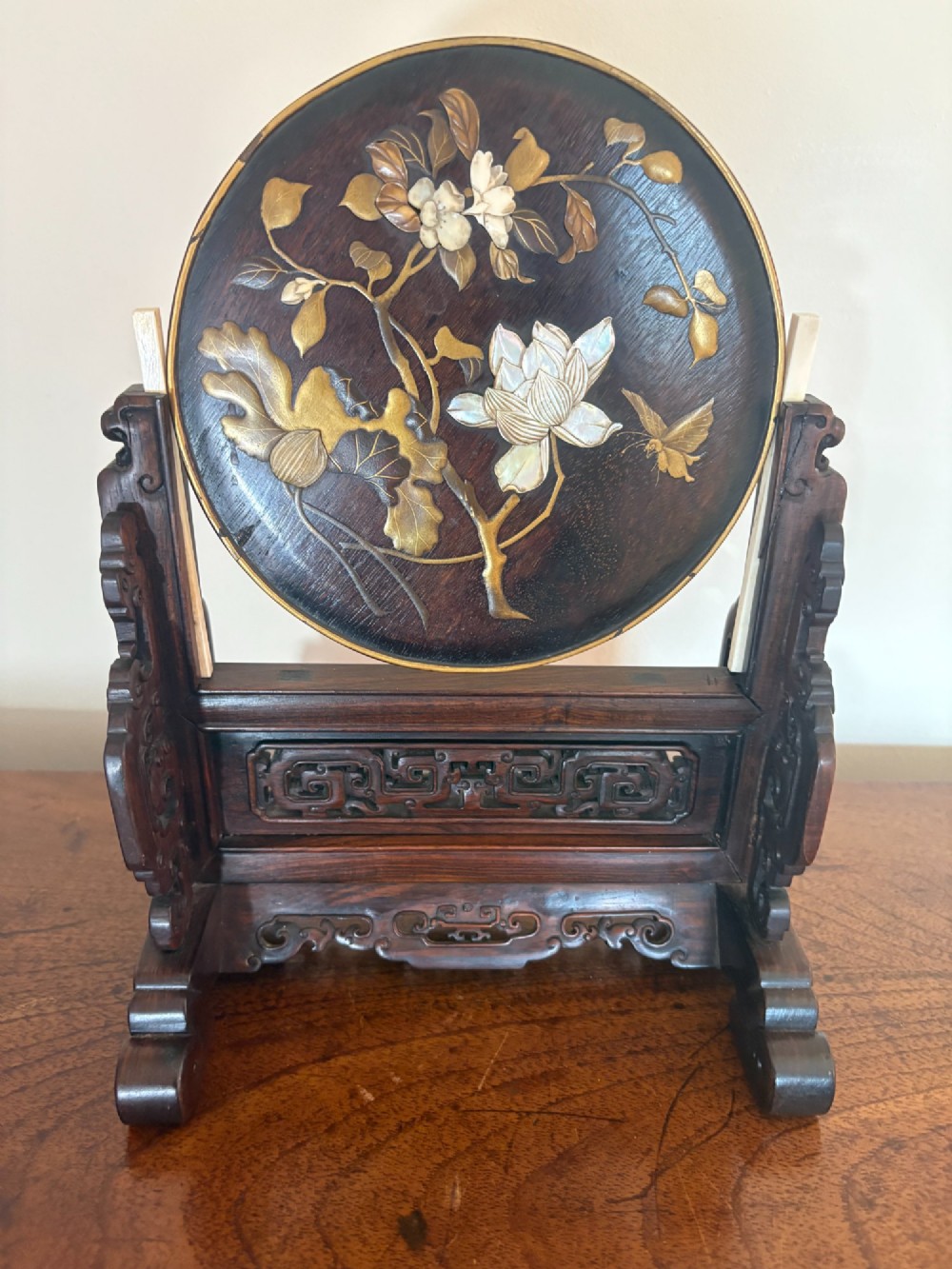 A circular dark wood Japanese table screen featuring raised mother-of-pearl floral and insect inlays, set within a carved hardwood stand. View IV