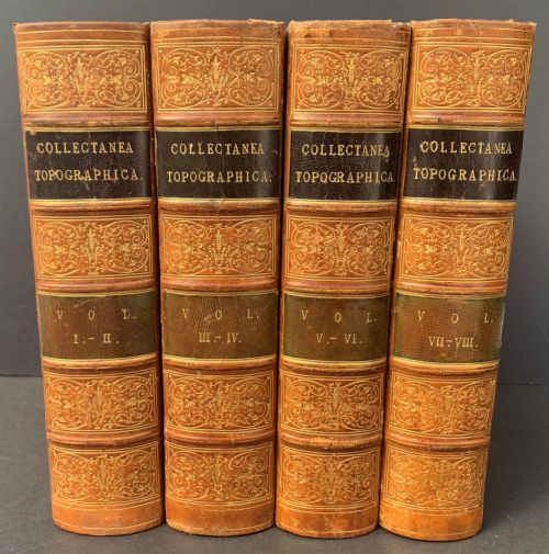 fig 1. Four antique tan leather-bound volumes with ornate gold gilt decoration and dark title labels on the spines.
