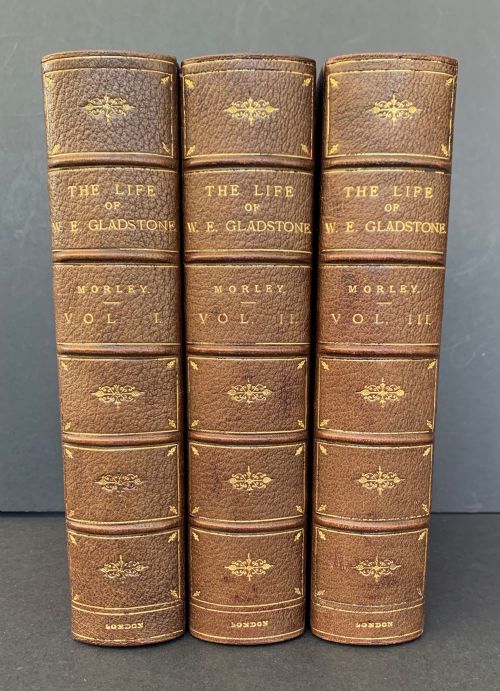 fig 1. A three-volume set of Edwardian books titled The Life of W E Gladstone, bound in brown half-leather with red cloth sides and gilt spine ornamentation.