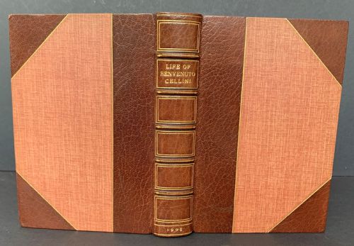 fig 1. An Edwardian half-leather bound volume titled The Life of Benvenuto Cellini with gilt spine lettering, raised bands, and terracotta cloth boards.
