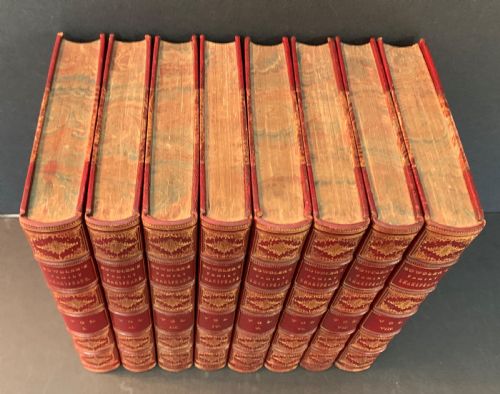 fig 1. An eight-volume set of 1827 leather-bound books titled Bowdlers Family Shakspeare with red leather spines, raised bands, and gilt decoration.
