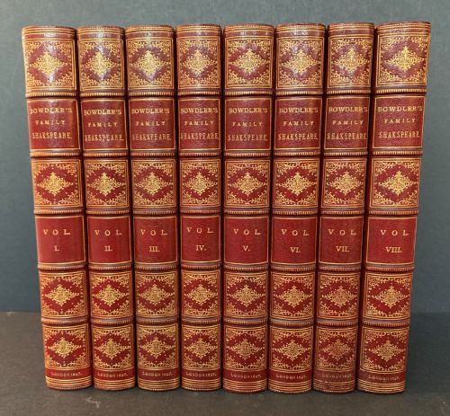 fig 2. An eight-volume set of 1827 leather-bound books titled Bowdlers Family Shakspeare with red leather spines, raised bands, and gilt decoration.