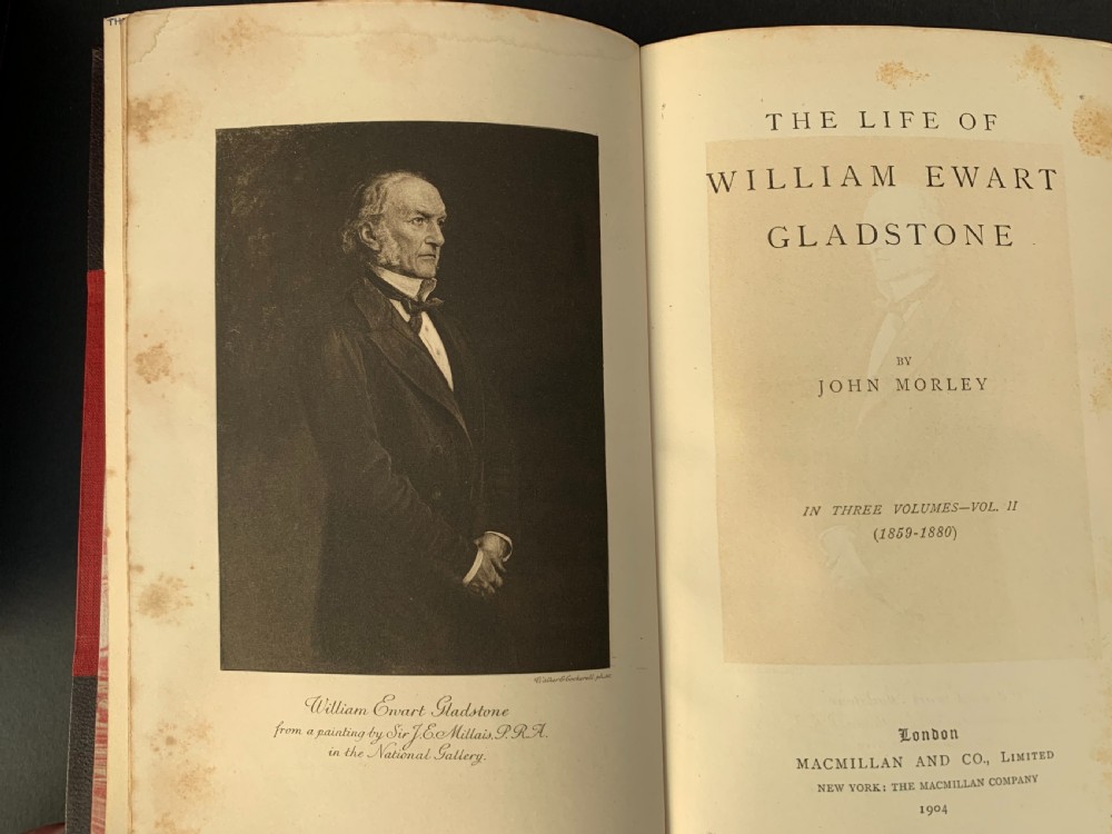 A three-volume set of Edwardian books titled The Life of W E Gladstone, bound in brown half-leather with red cloth sides and gilt spine ornamentation. View XV