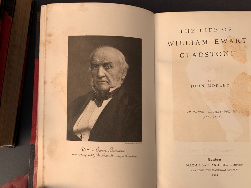 A three-volume set of Edwardian books titled The Life of W E Gladstone, bound in brown half-leather with red cloth sides and gilt spine ornamentation. View XVI