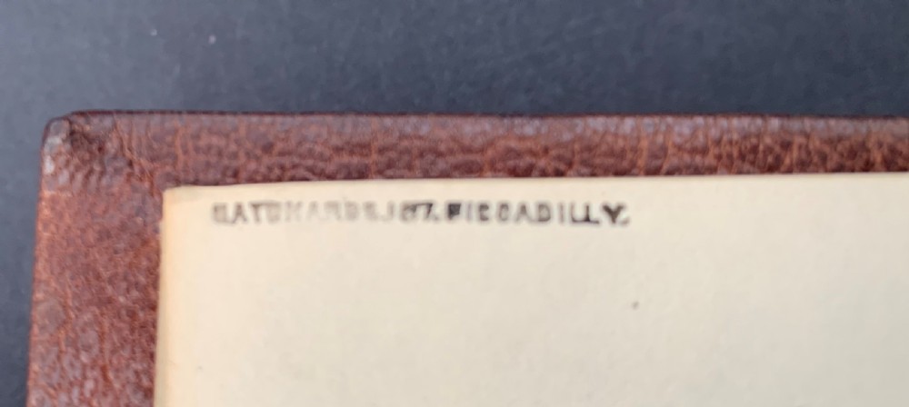 An Edwardian half-leather bound volume titled The Life of Benvenuto Cellini with gilt spine lettering, raised bands, and terracotta cloth boards. View V