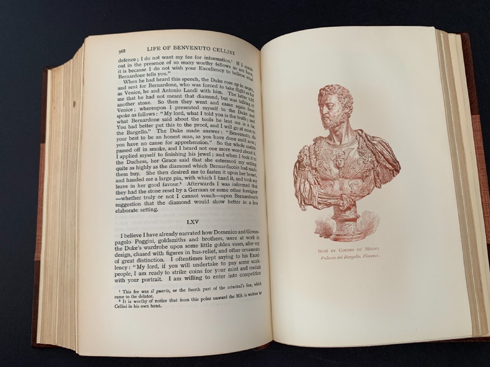 An Edwardian half-leather bound volume titled The Life of Benvenuto Cellini with gilt spine lettering, raised bands, and terracotta cloth boards. View XIII