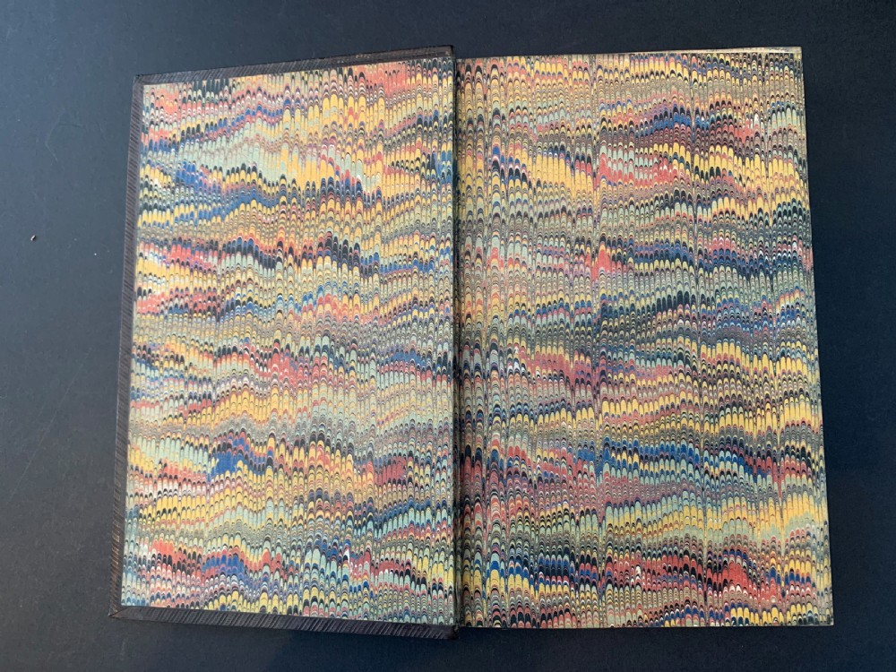 A set of four early 19th-century leather-bound books featuring gilt tooling and titles along their dark reddish-brown spines. View VII