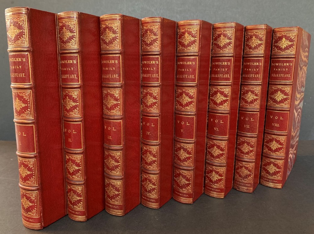 An eight-volume set of 1827 leather-bound books titled Bowdlers Family Shakspeare with red leather spines, raised bands, and gilt decoration.