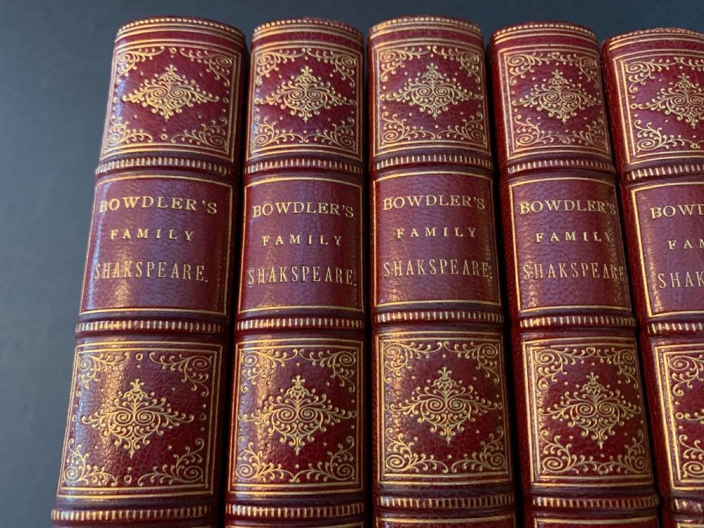 An eight-volume set of 1827 leather-bound books titled Bowdlers Family Shakspeare with red leather spines, raised bands, and gilt decoration. View VII