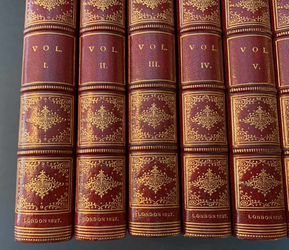 An eight-volume set of 1827 leather-bound books titled Bowdlers Family Shakspeare with red leather spines, raised bands, and gilt decoration. View VIII