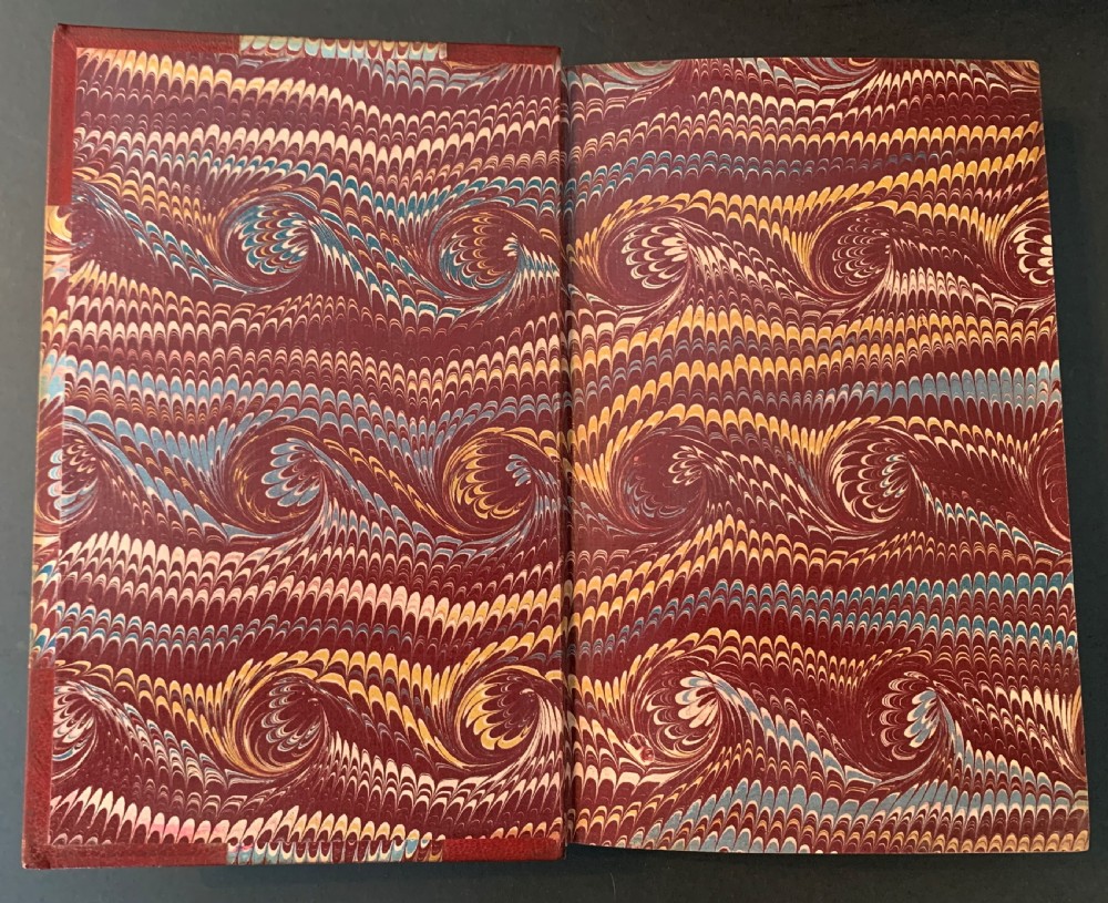 An eight-volume set of 1827 leather-bound books titled Bowdlers Family Shakspeare with red leather spines, raised bands, and gilt decoration. View IX
