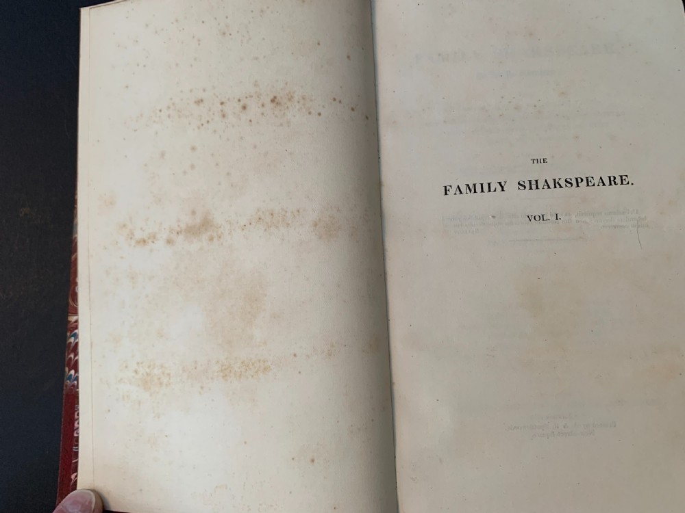 An eight-volume set of 1827 leather-bound books titled Bowdlers Family Shakspeare with red leather spines, raised bands, and gilt decoration. View XI