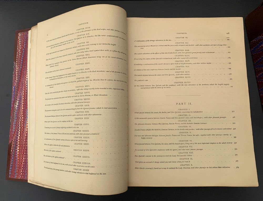 Pair of Victorian half-leather bound books with warm brown spines, gilt lettering on black labels, and red and blue marbled paper boards. View VII