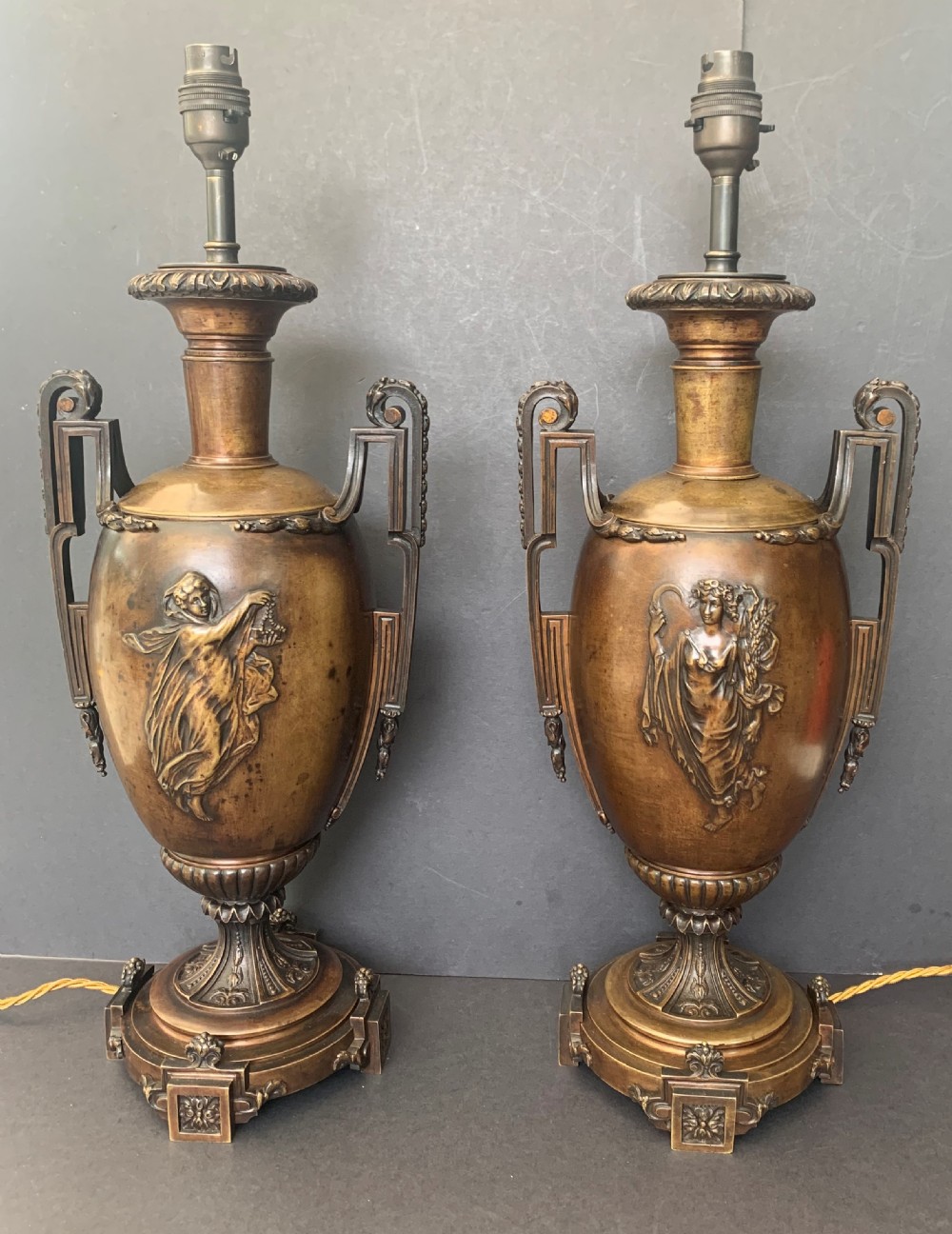 Pair of antique French twin handled bronze urns of classical inspiration later converted to table lamps