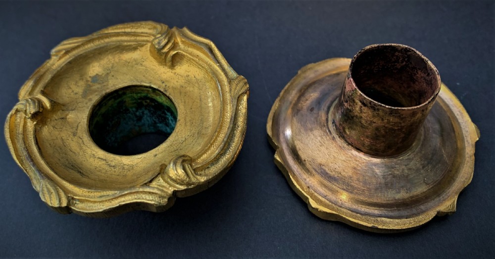 A pair of 19th-century French ormolu candlesticks featuring intricate acanthus leaf carving, rocaille shell motifs, and a gilded finish. View III