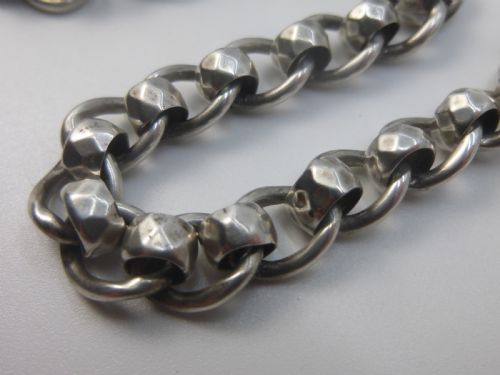 fig 1. A Victorian sterling silver Albert pocket watch chain featuring heavy curb links, a T-bar fastener, and a swivel clasp.
