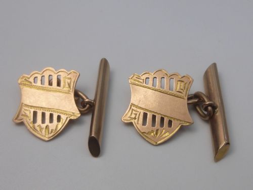 fig 1. A pair of Edwardian 9ct rose gold cufflinks featuring pierced shield-shaped faces linked to torpedo backs.