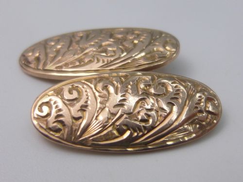 fig 1. A set of four Edwardian nine-carat rose gold oval cufflink faces with hand-engraved scrollwork motifs.