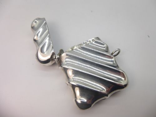 fig 1. A Victorian silver vesta case featuring a diagonal fluted design, hinged lid, and side suspension ring.