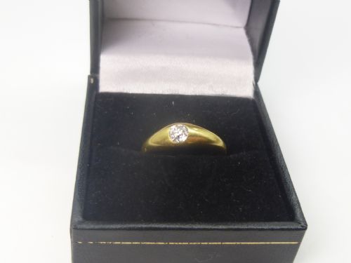 fig 1. A Victorian 18ct yellow gold gypsy ring featuring a centrally inset round diamond within a smooth tapered band.