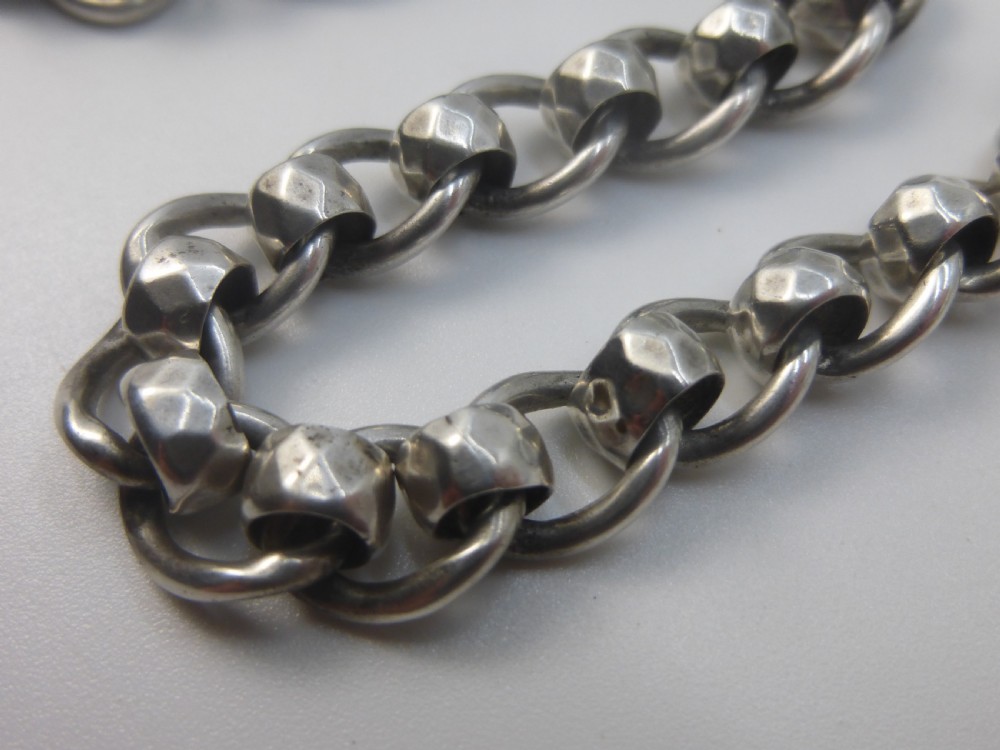 A Victorian sterling silver Albert pocket watch chain featuring heavy curb links, a T-bar fastener, and a swivel clasp. View II