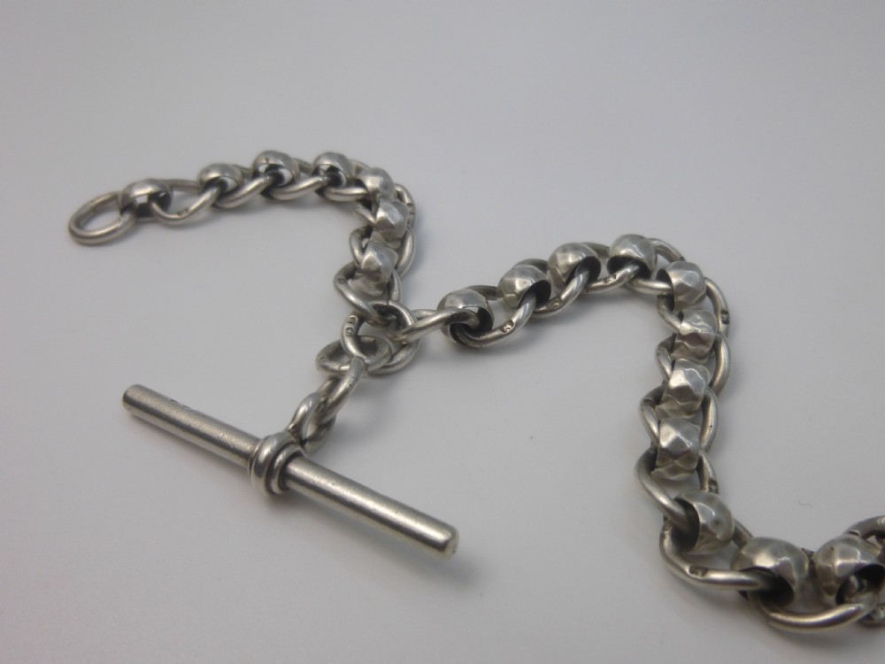 A Victorian sterling silver Albert pocket watch chain featuring heavy curb links, a T-bar fastener, and a swivel clasp. View III