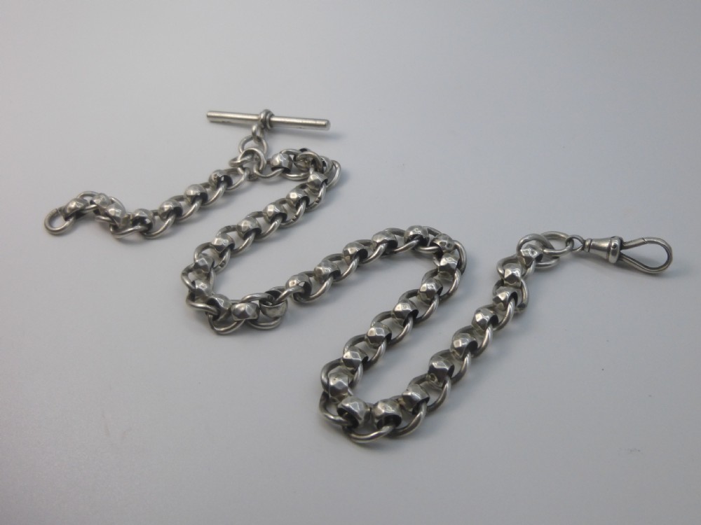 A Victorian sterling silver Albert pocket watch chain featuring heavy curb links, a T-bar fastener, and a swivel clasp. View V