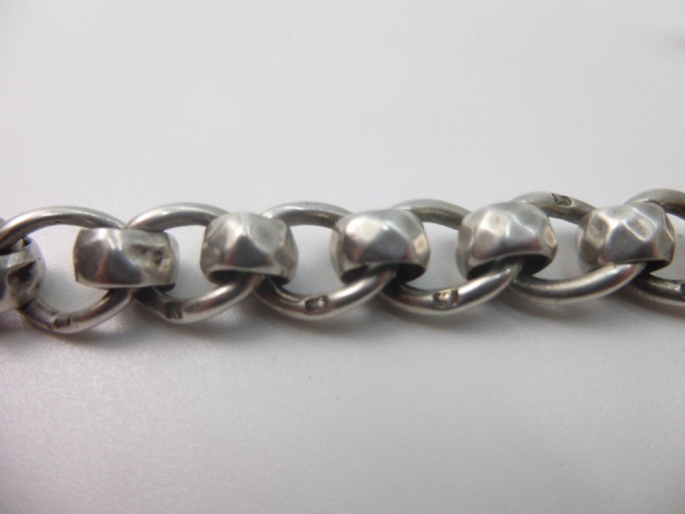 A Victorian sterling silver Albert pocket watch chain featuring heavy curb links, a T-bar fastener, and a swivel clasp. View VII