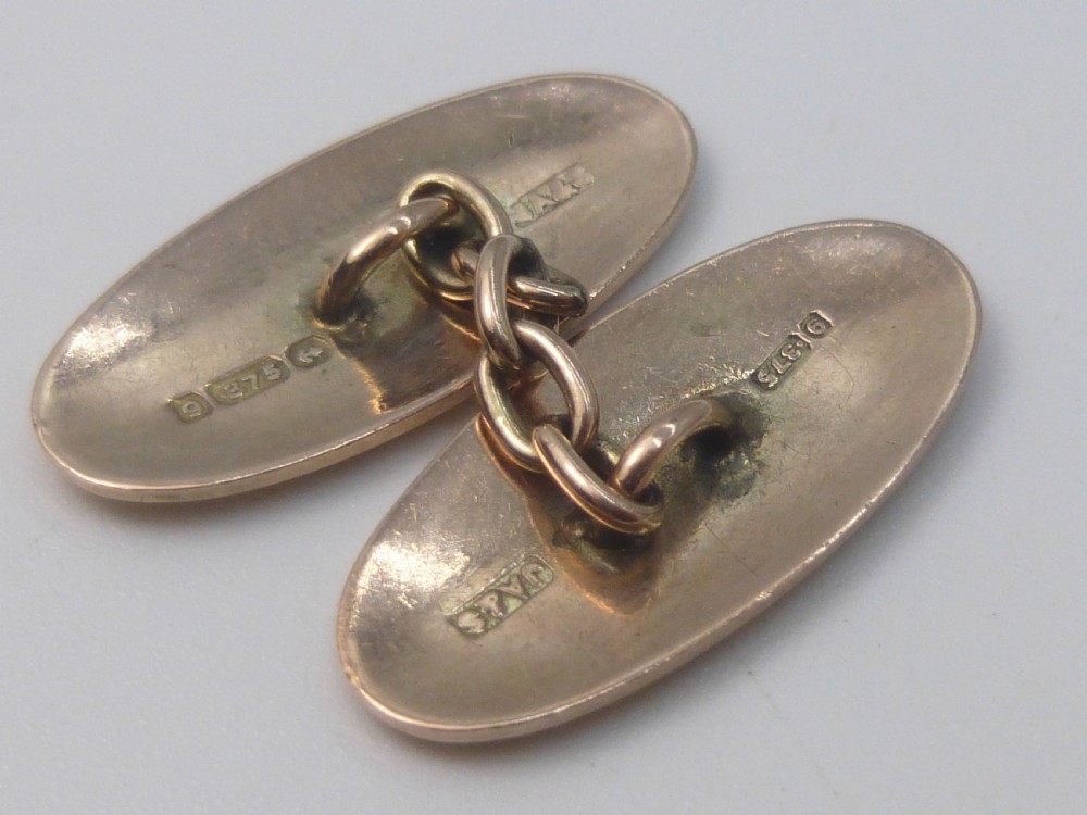 A set of four Edwardian nine-carat rose gold oval cufflink faces with hand-engraved scrollwork motifs. View VI