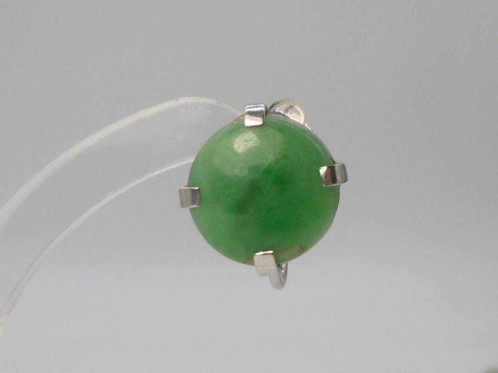 Pair of round green jadeite cabochon earrings set in four-prong white gold mounts with screw-back fittings. View III