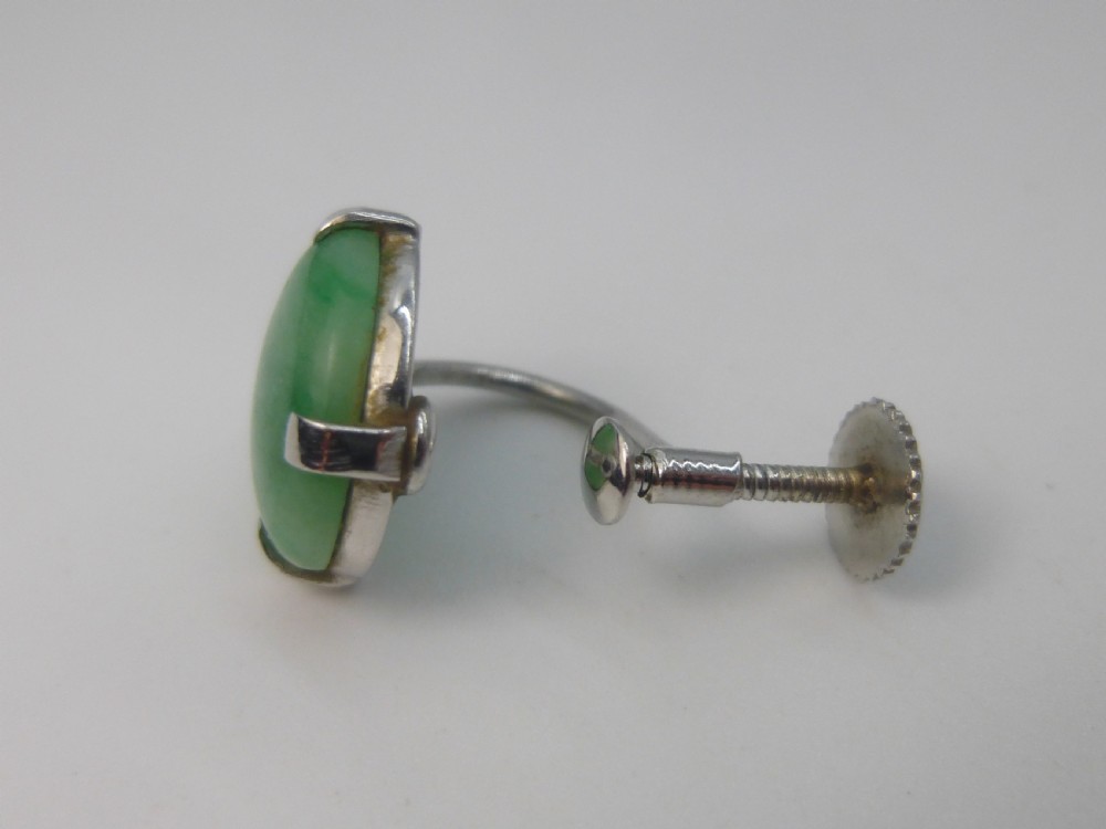 Pair of round green jadeite cabochon earrings set in four-prong white gold mounts with screw-back fittings. View IV