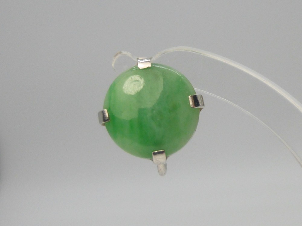 Pair of round green jadeite cabochon earrings set in four-prong white gold mounts with screw-back fittings. View VII