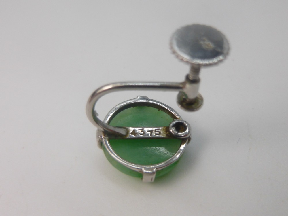 Pair of round green jadeite cabochon earrings set in four-prong white gold mounts with screw-back fittings. View VIII