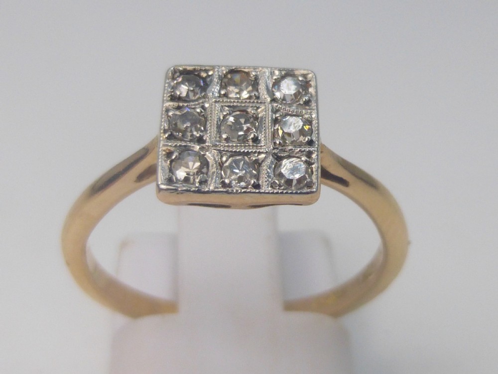 An Edwardian ring featuring a square setting containing nine diamonds in a three-by-three grid atop an 18ct yellow gold band. View III