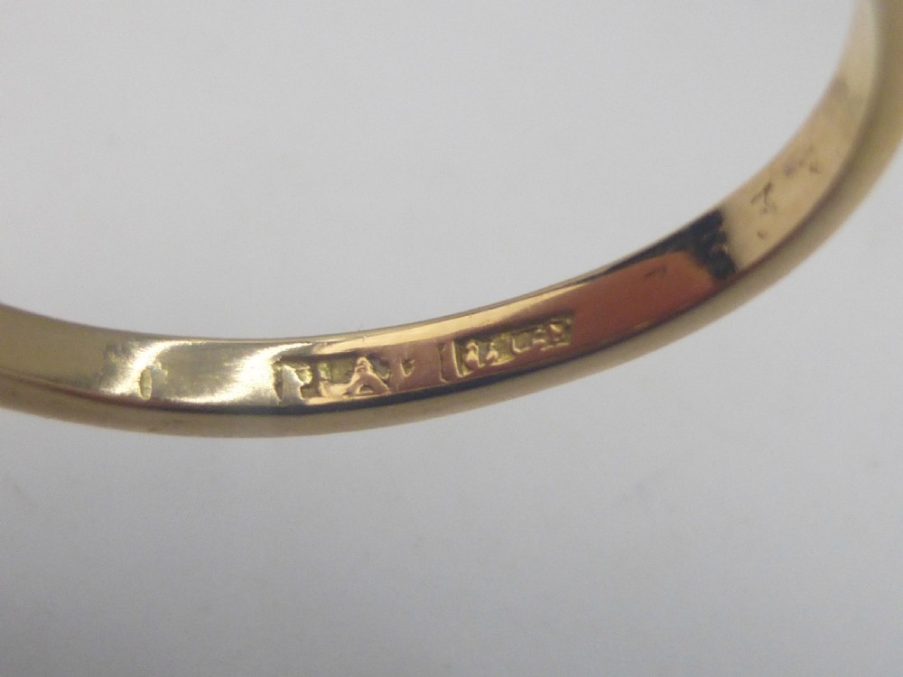 An Edwardian ring featuring a square setting containing nine diamonds in a three-by-three grid atop an 18ct yellow gold band. View IV