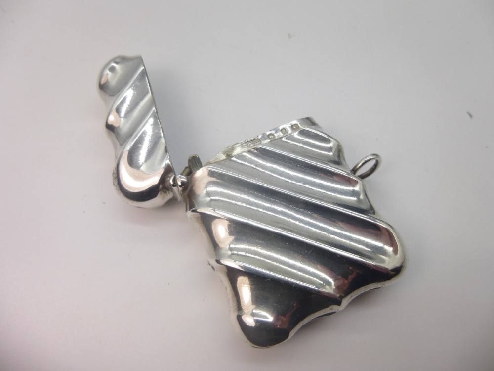 A Victorian silver vesta case featuring a diagonal fluted design, hinged lid, and side suspension ring. View II