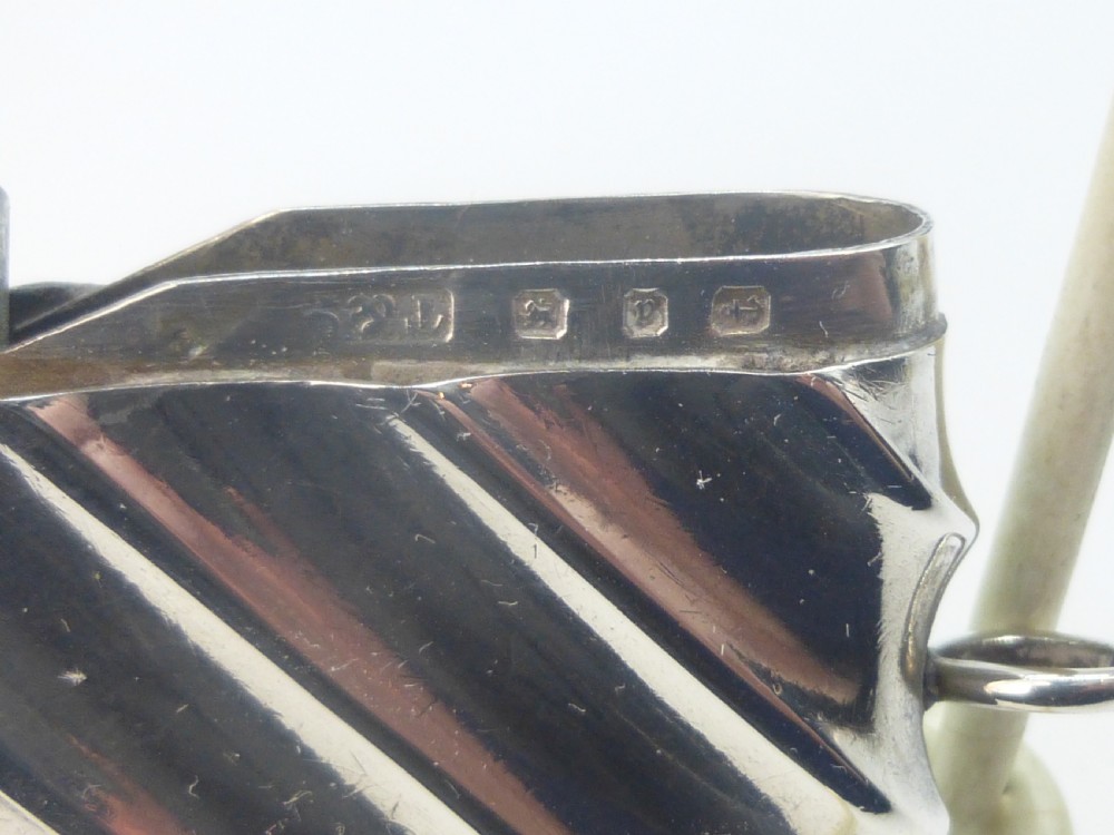 A Victorian silver vesta case featuring a diagonal fluted design, hinged lid, and side suspension ring. View III