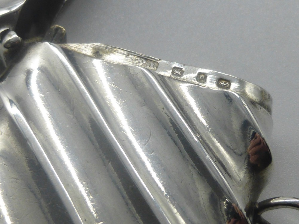 A Victorian silver vesta case featuring a diagonal fluted design, hinged lid, and side suspension ring. View IV