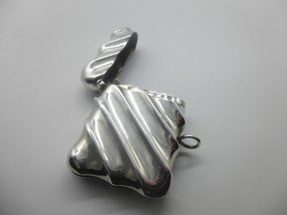 A Victorian silver vesta case featuring a diagonal fluted design, hinged lid, and side suspension ring. View V